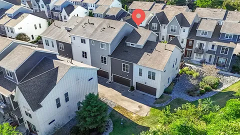 an aerial view of residential houses with yard