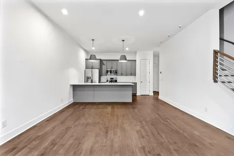 a large kitchen with a lot of counter space and stainless steel appliances
