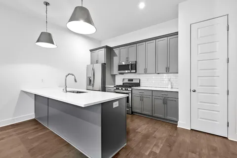 a kitchen with a sink stainless steel appliances and cabinets