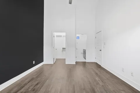 a view of an empty room with wooden floor