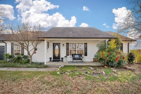 a front view of house with yard and outdoor seating