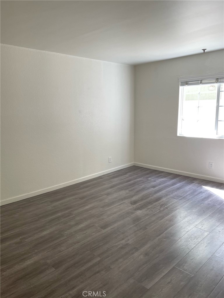 10920 Moorpark Street North Hollywood, CA 91602 - Photo 12 of 15 wooden floor in an empty room with a window