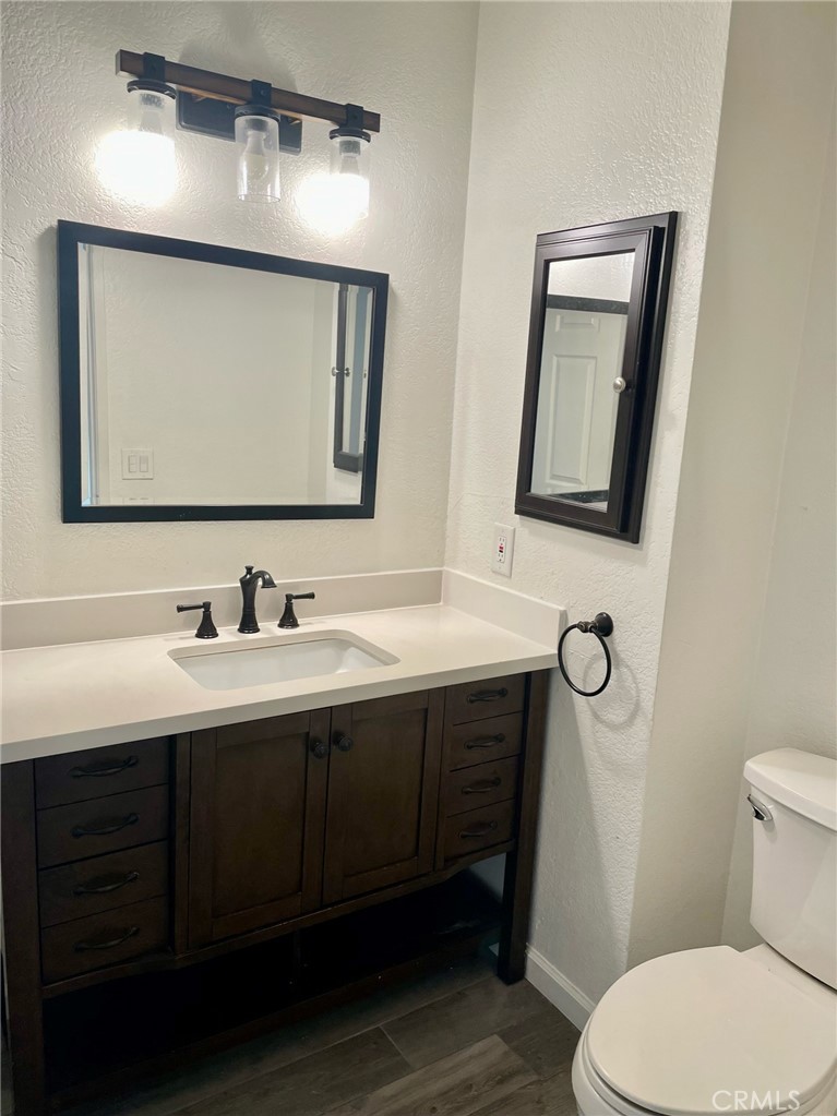 10920 Moorpark Street North Hollywood, CA 91602 - Photo 15 of 15 a bathroom with a toilet sink and mirror