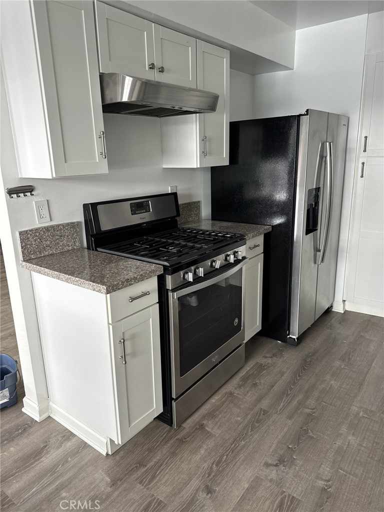 10920 Moorpark Street North Hollywood, CA 91602 - Photo 8 of 15 a kitchen with stainless steel appliances granite countertop a stove a refrigerator and a microwave