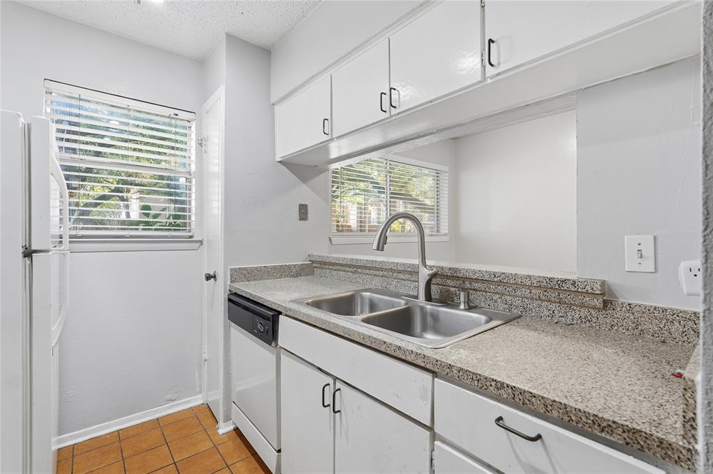 4211 Holland Avenue, Unit 105 Dallas, TX 75219 - Photo 13 of 26 a kitchen with a sink and cabinets
