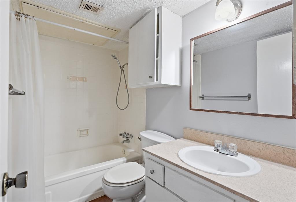 4211 Holland Avenue, Unit 105 Dallas, TX 75219 - Photo 18 of 26 a bathroom with a sink toilet and shower