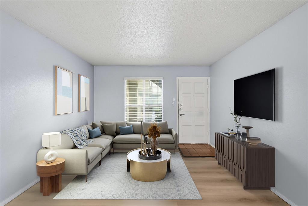 4211 Holland Avenue, Unit 105 Dallas, TX 75219 - Photo 2 of 26 a living room with furniture and a flat screen tv