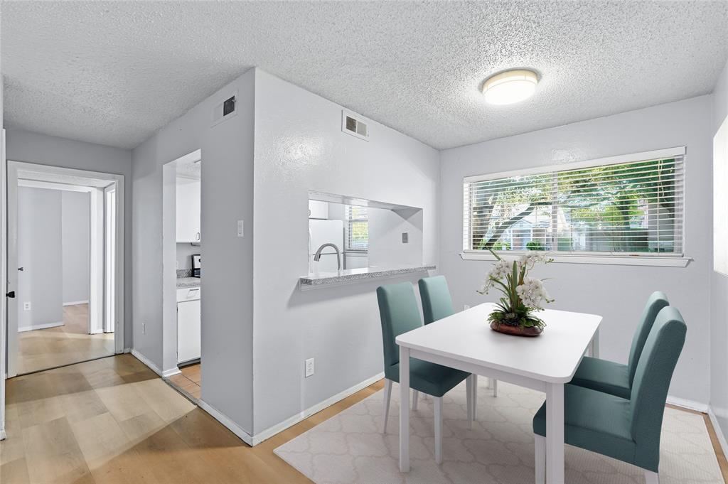 4211 Holland Avenue, Unit 105 Dallas, TX 75219 - Photo 3 of 26 a view of a dining room with a table and chairs