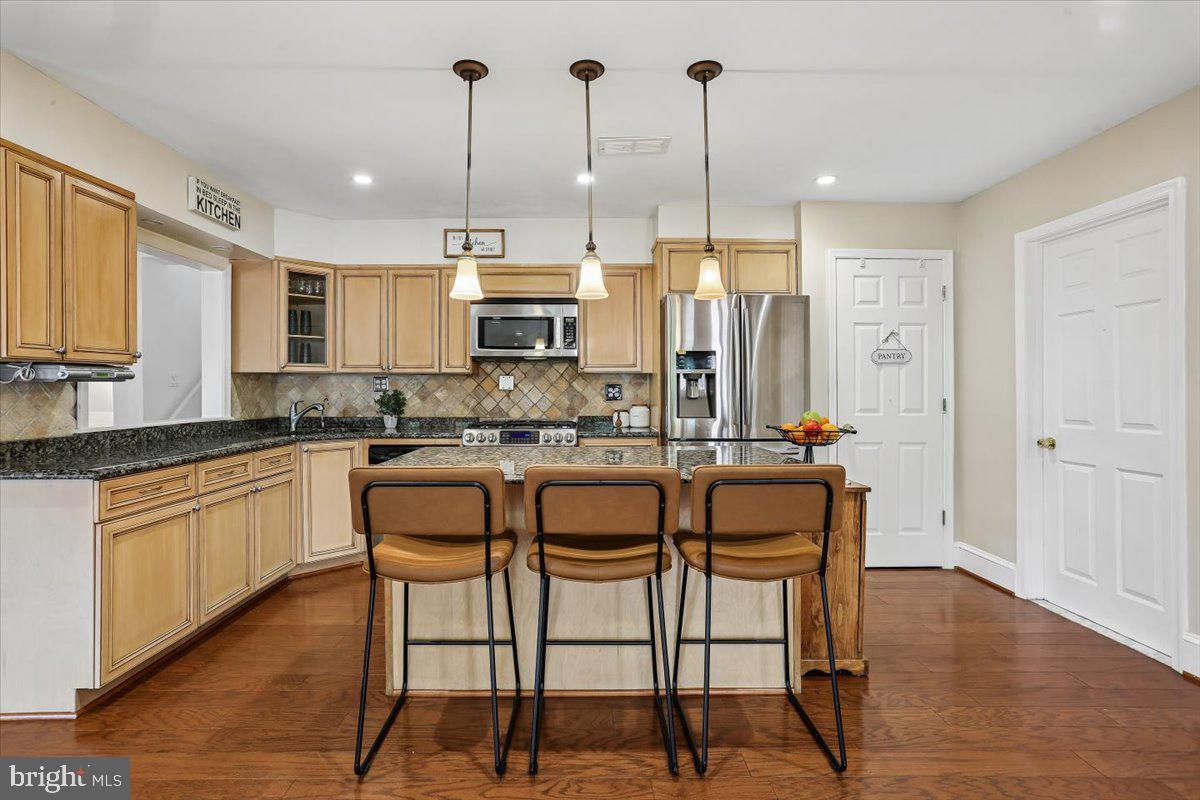 3709 Kenway Street Silver Spring, MD 20906 - Photo 5 of 34 a kitchen with stainless steel appliances granite countertop a stove a sink refrigerator and a wooden cabinets