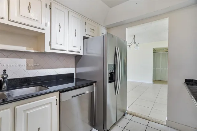 a kitchen with a refrigerator and cabinets