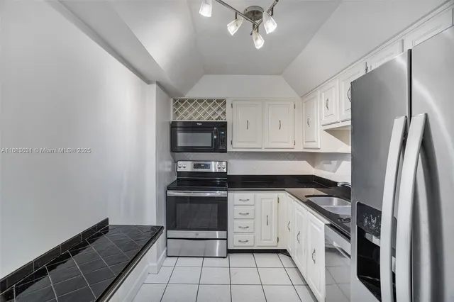 a kitchen with a sink stainless steel appliances and cabinets