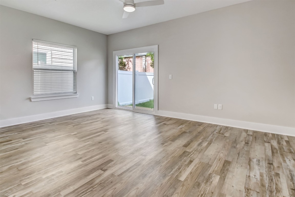 926 South 7th Street Fernandina Beach, FL 32034 - Photo 11 of 37 an empty room with wooden floor and windows