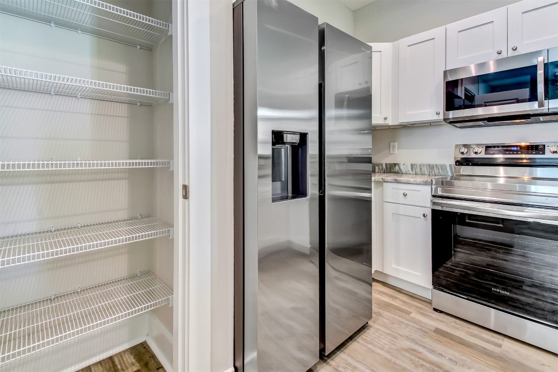926 South 7th Street Fernandina Beach, FL 32034 - Photo 15 of 37 a kitchen with cabinets and stainless steel appliances