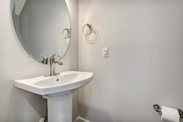 a bathroom with a sink and mirror