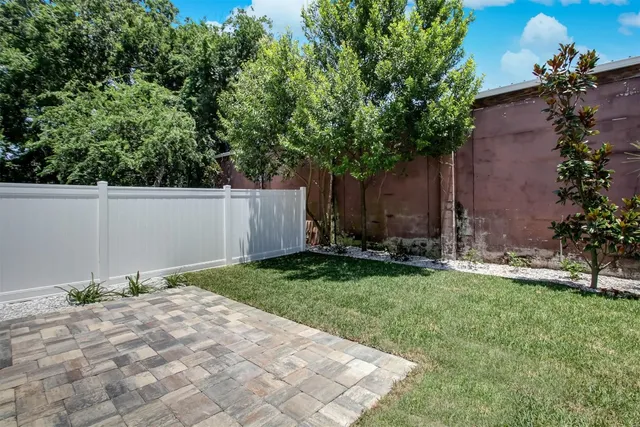 a backyard of a house with plants and trees