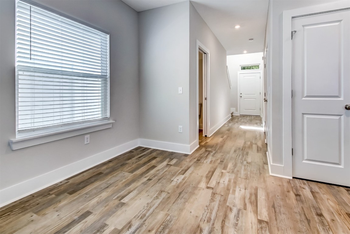 926 South 7th Street Fernandina Beach, FL 32034 - Photo 4 of 37 a view of hallway with a bed and wooden floor