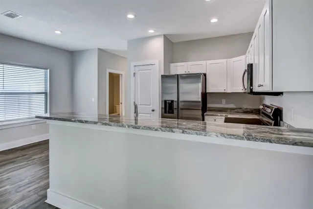 a view of counter top space and stainless steel appliances