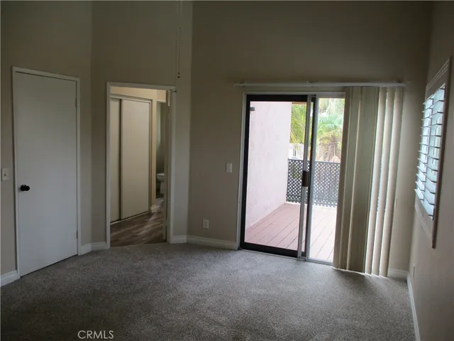 a view of an empty room and a balcony