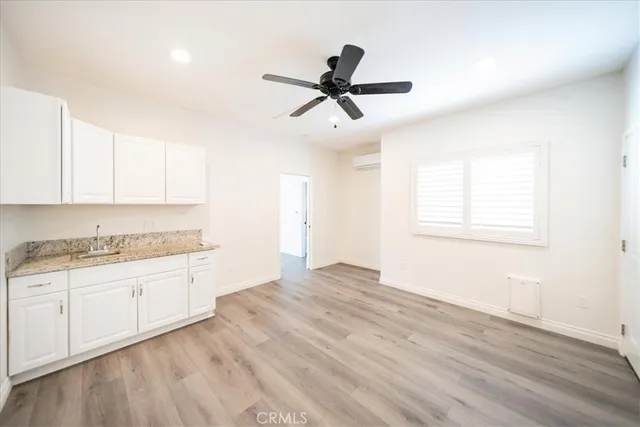 a view of a kitchen and a sink dishwasher with wooden floor