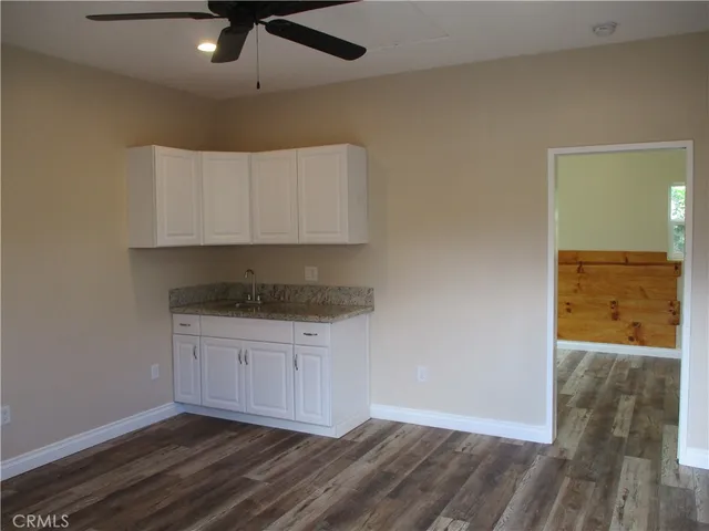 a view of a kitchen counter space and wooden floor