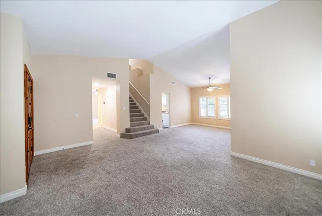 a view of an empty room with stairs