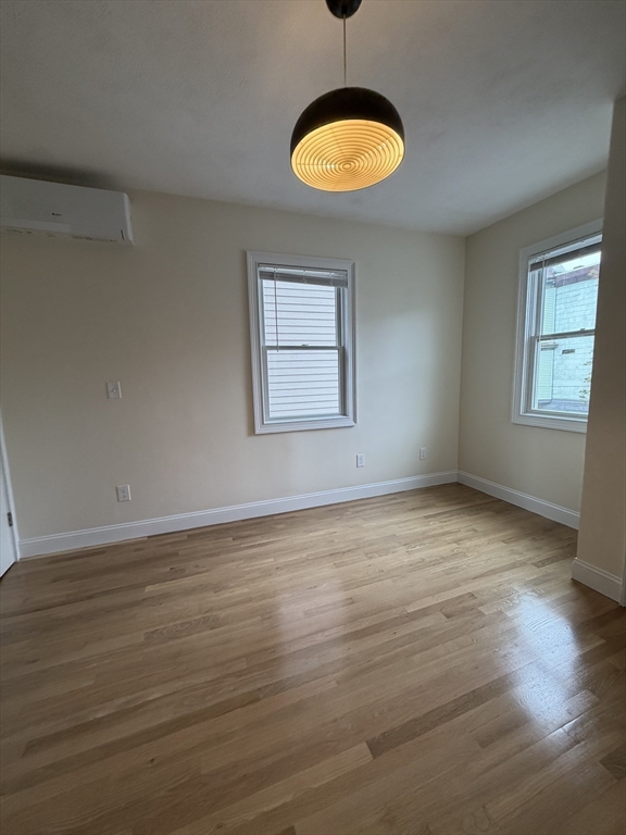 26 Brooks Street, Unit 2 Boston, MA 02128 - Photo 8 of 12 an empty room with wooden floor and windows