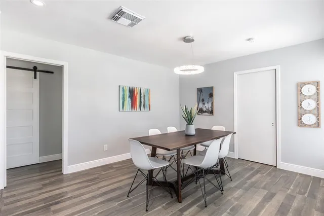 a view of a dining room with furniture and wooden floor