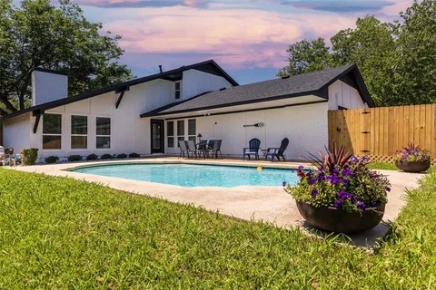 a view of house with swimming pool yard and outdoor seating
