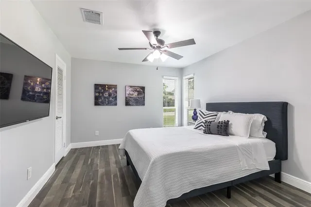 a bedroom with a bed and a ceiling fan