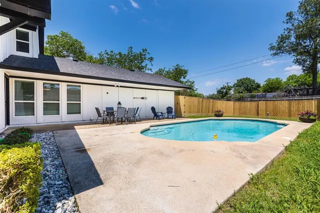 an aerial view of a house with swimming pool