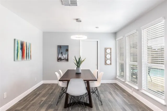 a view of a dining room with furniture and wooden floor