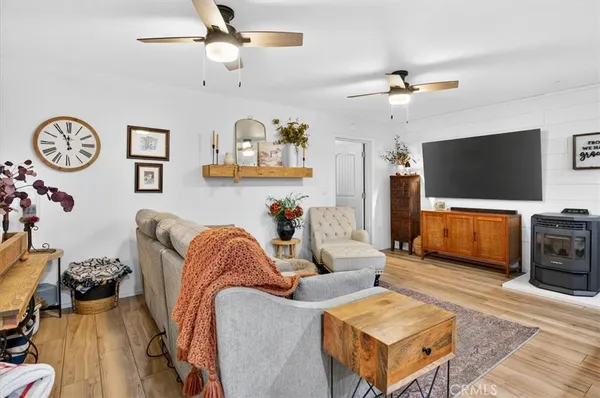 a bedroom with a bed a dresser and flat screen tv