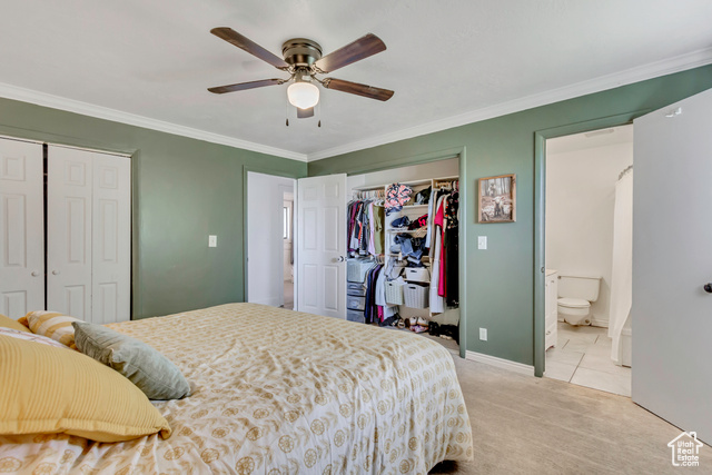 360 East Center Street Centerville, UT 84014 - Photo 17 of 41 Bedroom with two closets, carpet, ornamental molding, and a ceiling fan