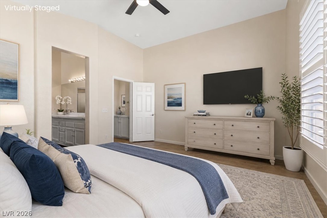 1007 Golden Ridge Court Henderson, NV 89052 - Photo 12 of 27 High ceilings and plantation shutters elevate this serene master bedroom suite with hardwood flooring.