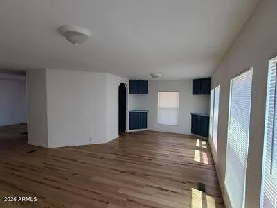a view of empty room with wooden floor and fireplace