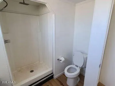 a bathroom with a granite countertop toilet and a sink