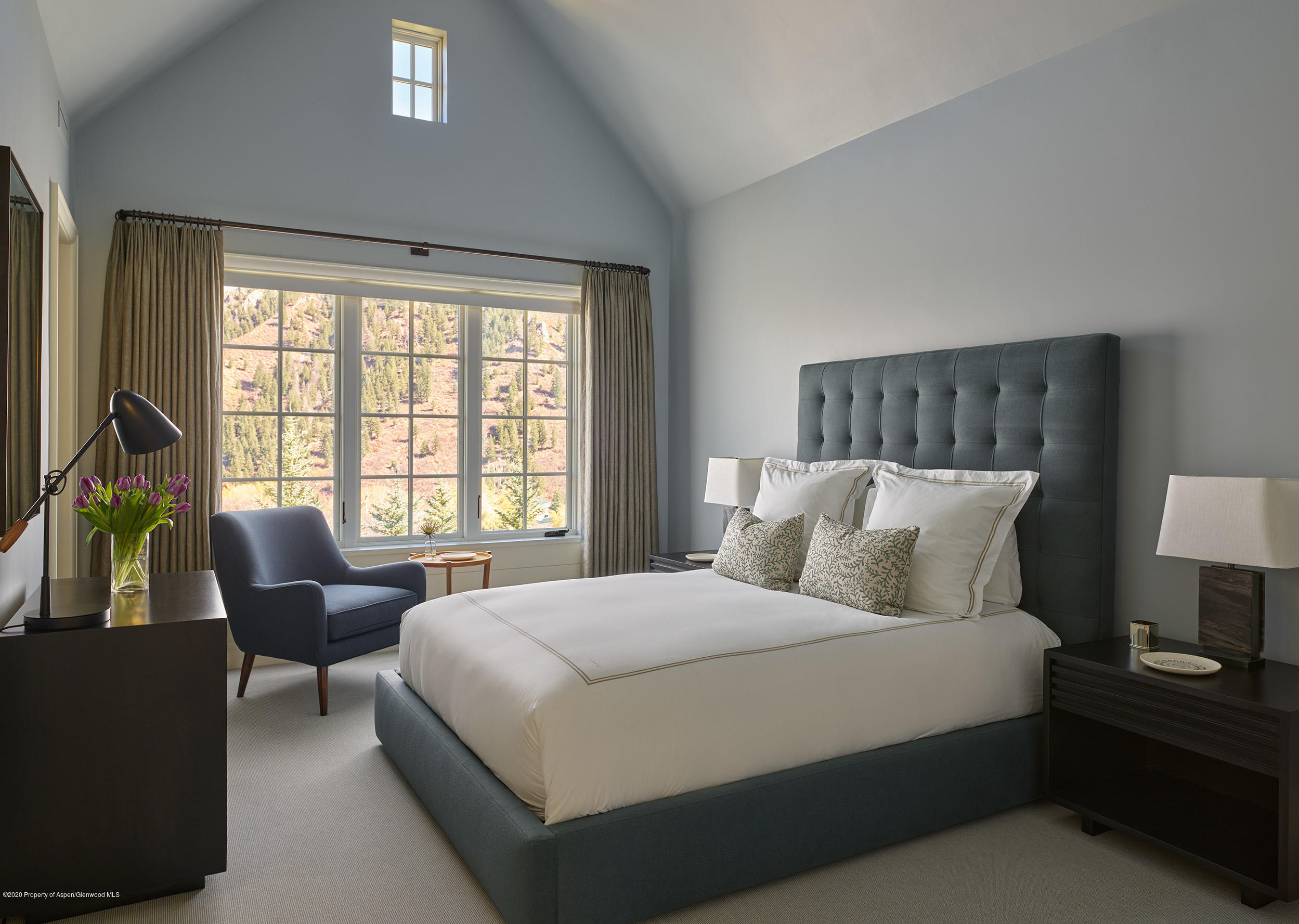 864 Moore Drive Aspen, CO 81611 - Photo 20 of 37 a bedroom with a bed and a couch next to a window