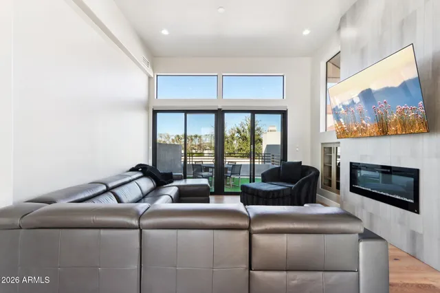a living room with furniture fireplace and flat screen tv