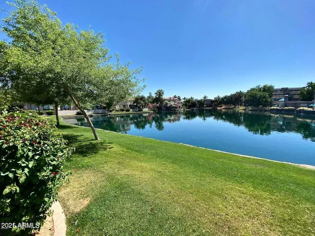 a view of a lake with a house in the background