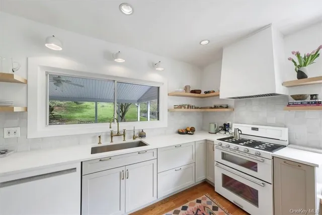 a kitchen with a sink stove and cabinets