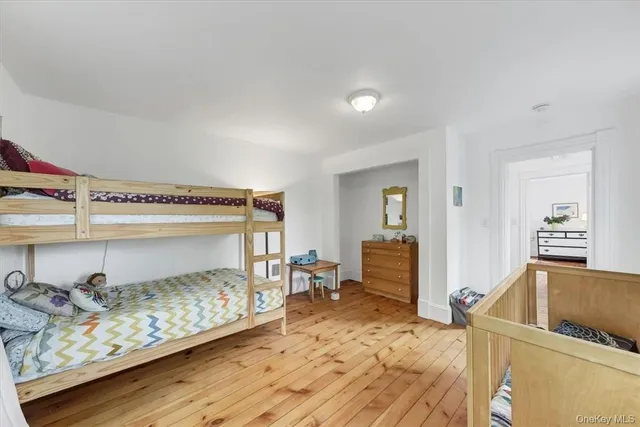 a bedroom with furniture and a wooden floor