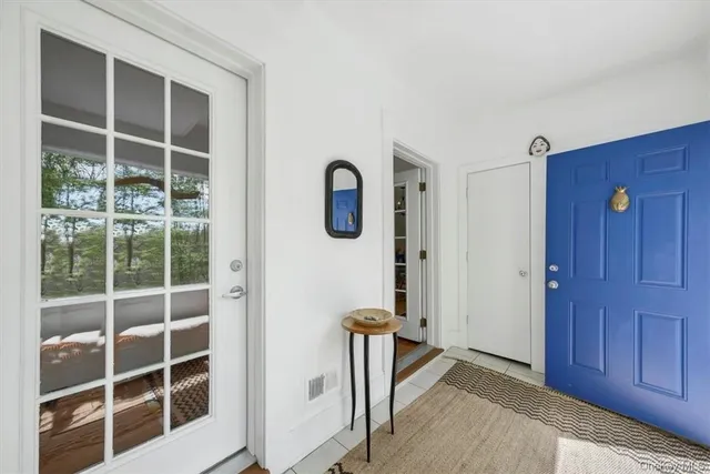 a view of a livingroom with wooden floor and windows