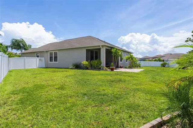 a view of a house with a yard and porch