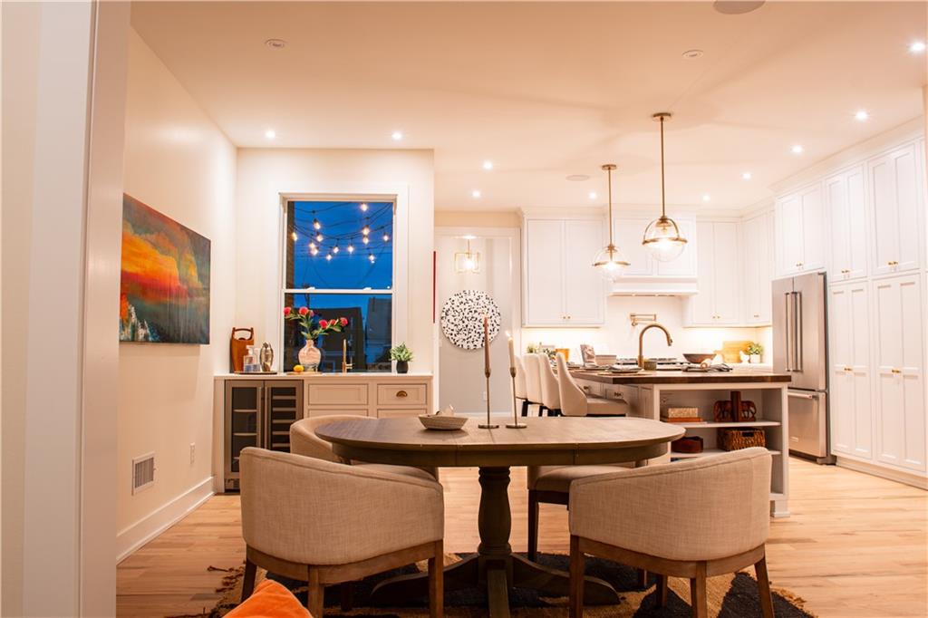 212 South Mathilda Street Pittsburgh, PA 15224 - Photo 11 of 38 a kitchen with a table chairs stove and cabinets