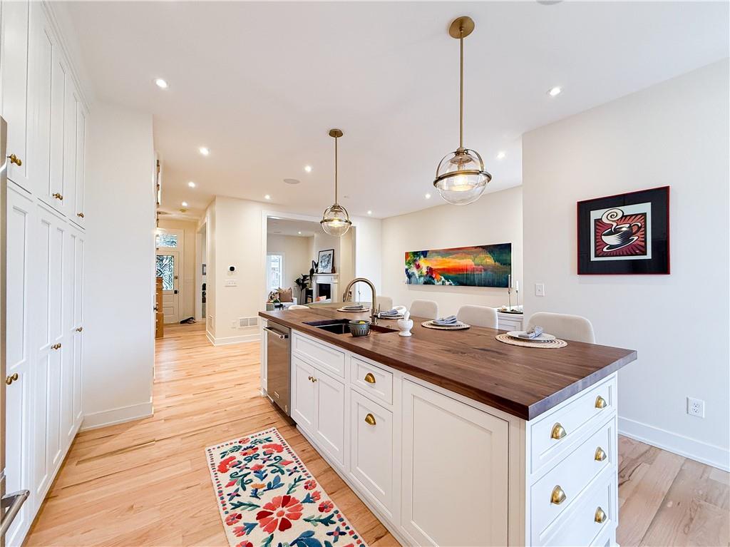 212 South Mathilda Street Pittsburgh, PA 15224 - Photo 13 of 38 a large kitchen with kitchen island a counter space a sink stainless steel appliances and cabinets