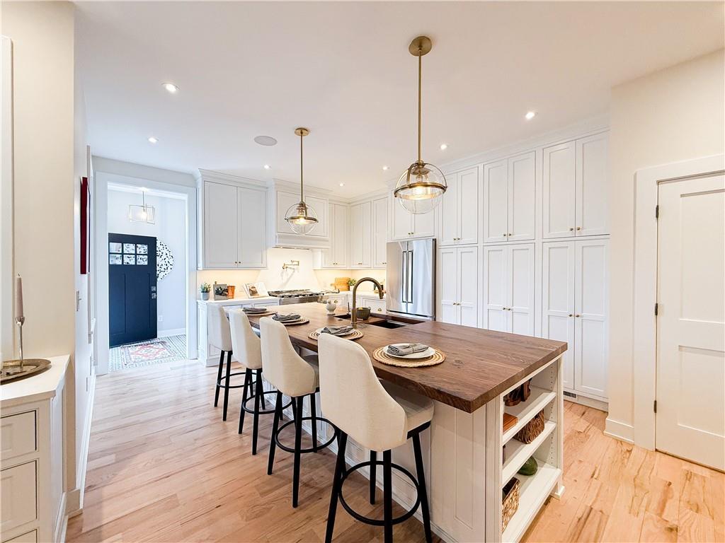 212 South Mathilda Street Pittsburgh, PA 15224 - Photo 14 of 38 a view of a dining room and livingroom with furniture wooden floor a chandelier