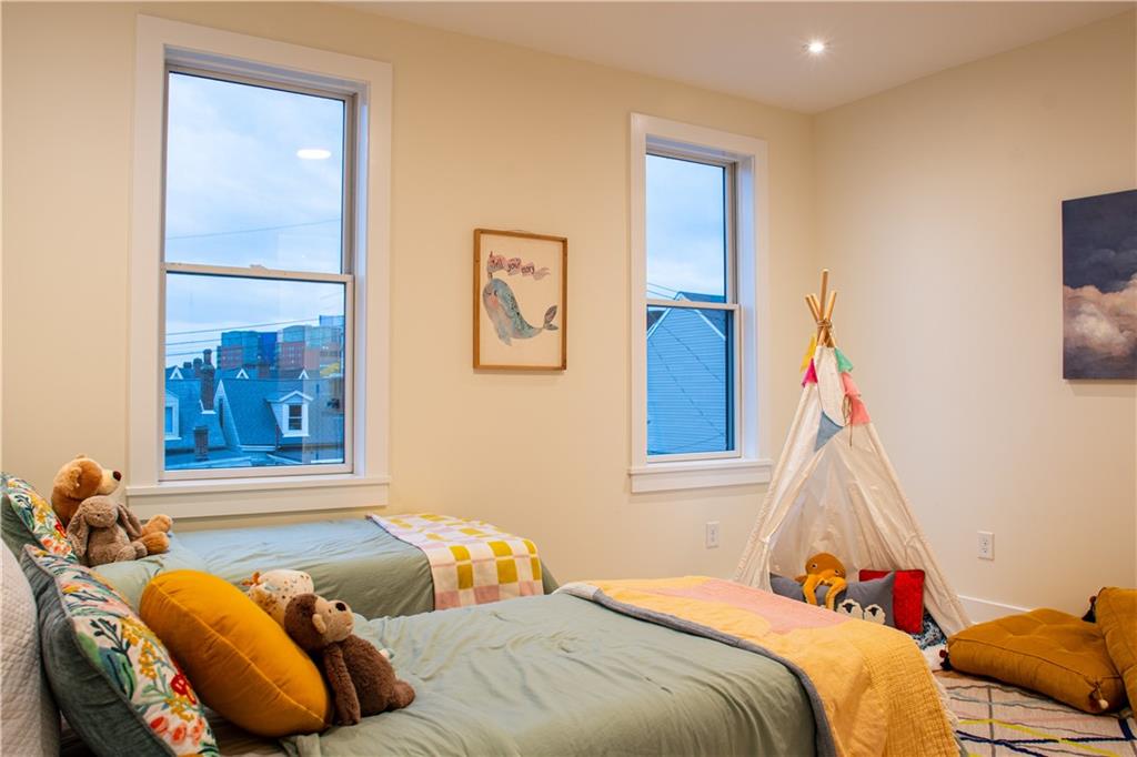 212 South Mathilda Street Pittsburgh, PA 15224 - Photo 25 of 38 a bedroom with a bed and a window