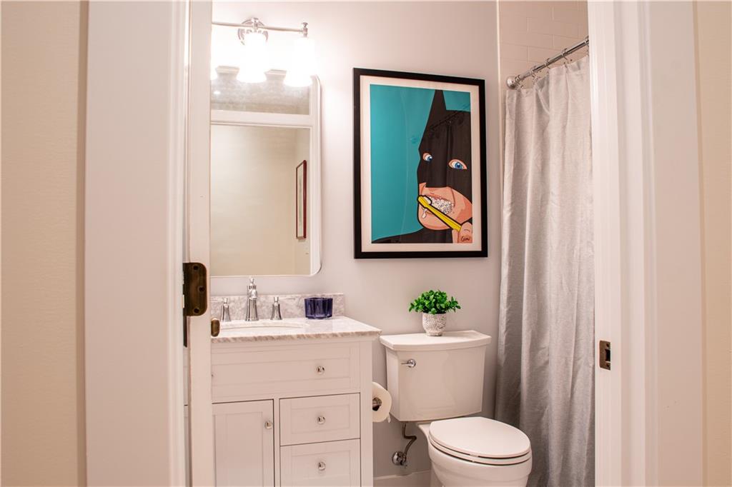 212 South Mathilda Street Pittsburgh, PA 15224 - Photo 26 of 38 a bathroom with a toilet a sink and a mirror