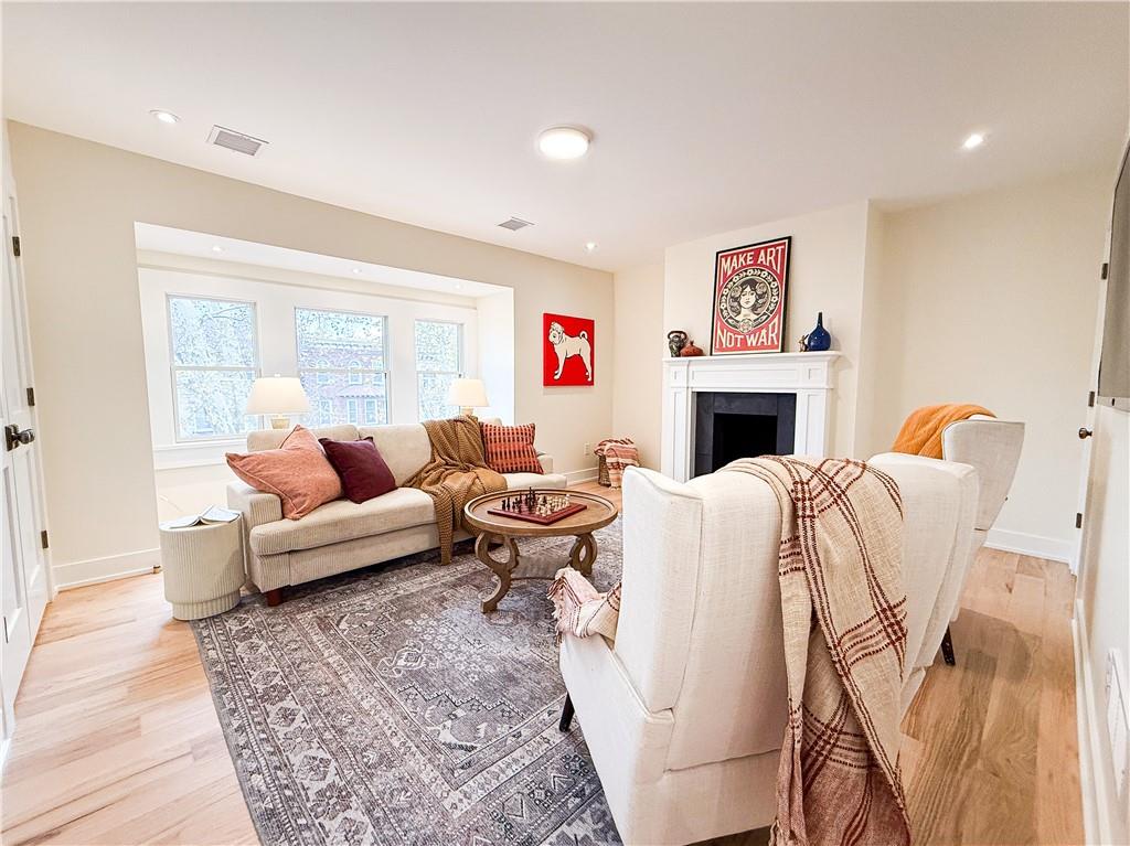 212 South Mathilda Street Pittsburgh, PA 15224 - Photo 28 of 38 a living room with furniture a fireplace and a floor to ceiling window