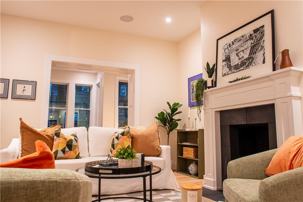 212 South Mathilda Street Pittsburgh, PA 15224 - Photo 9 of 38 a living room with furniture and a fireplace